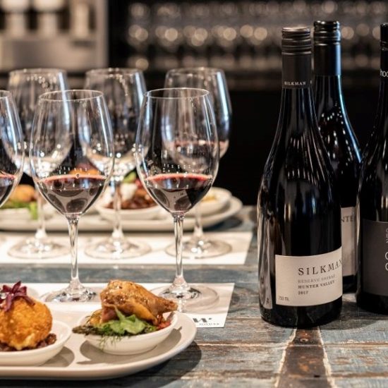 food and wine on a bench